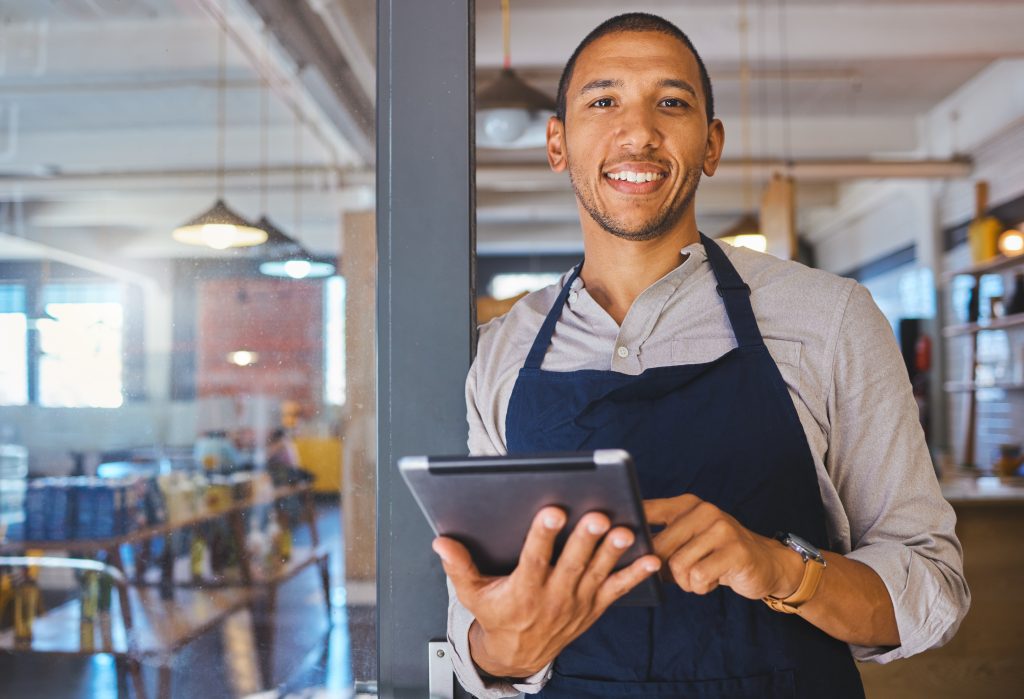 restaurant-entrepreneur-with-tablet-leaning-door-open-customers-portrait-owner-manager-employee-startup-fast-food-store-cafe-coffee-shop-business-standing-happy-with-smile