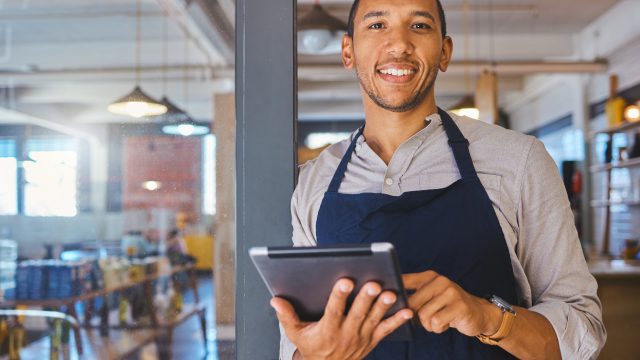 restaurant-entrepreneur-with-tablet-leaning-door-open-customers-portrait-owner-manager-employee-startup-fast-food-store-cafe-coffee-shop-business-standing-happy-with-smile